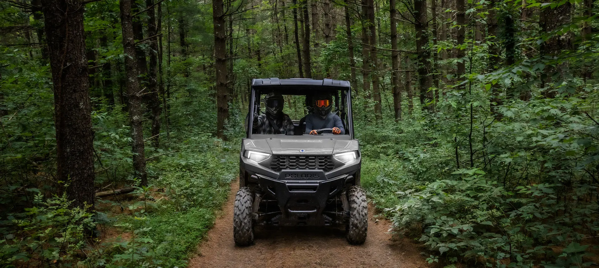 front view of a ranger sp 570 utv on a forest trail
