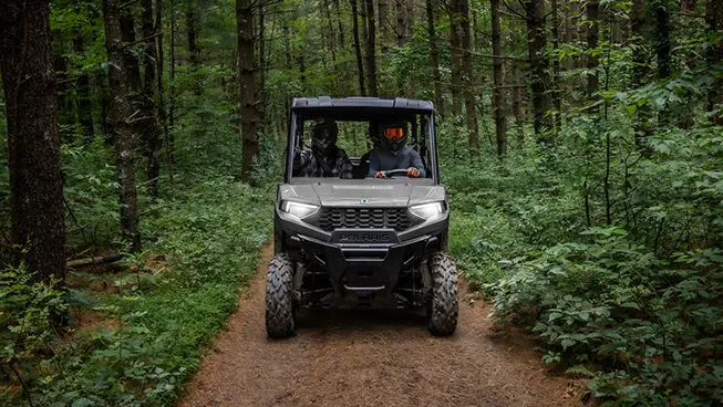 front view of a ranger sp 570 utv on a forest trail
