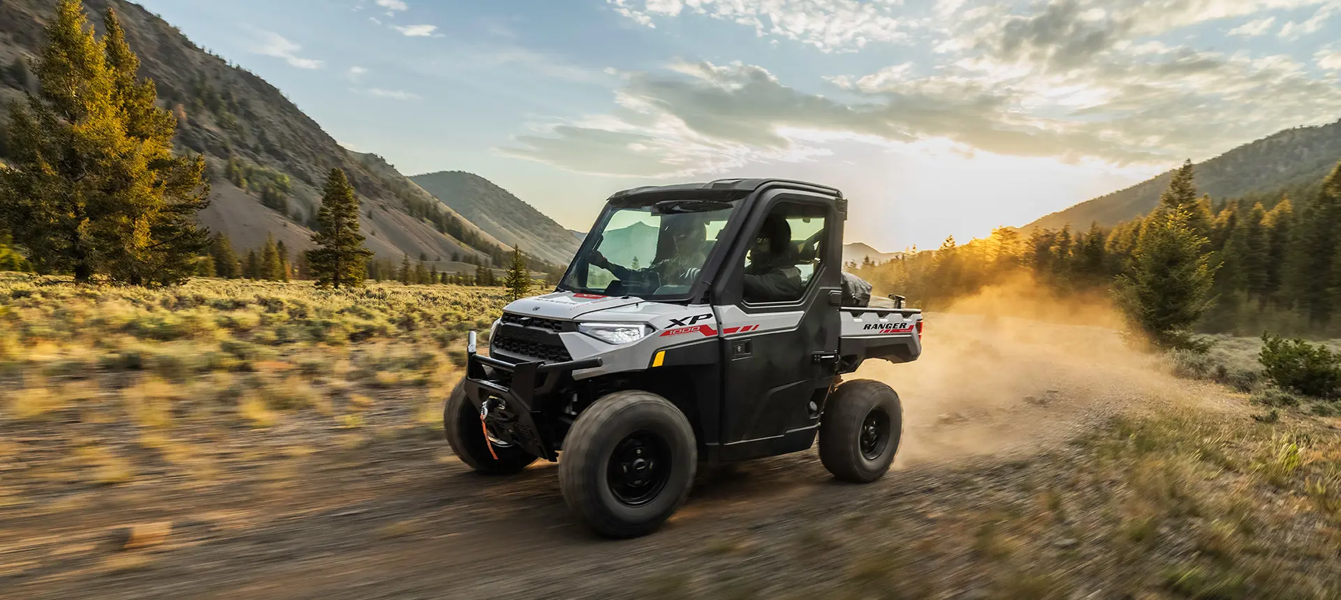 ranger xp 1000 northstar trail boss utv cruising on a field