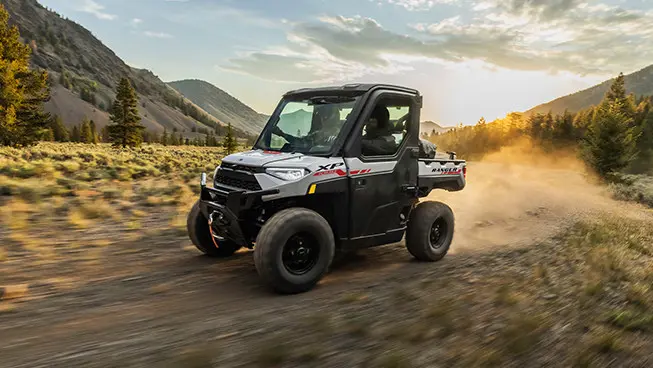 ranger xp 1000 northstar trail boss utv cruising on a field