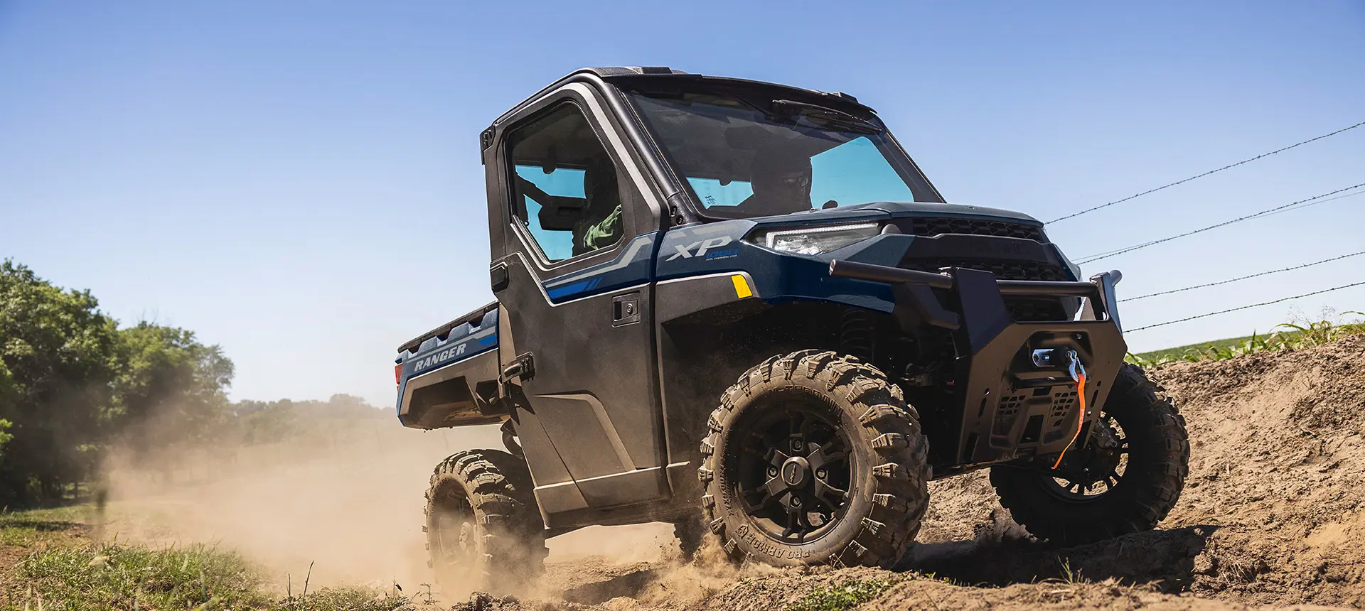 side profile of a ranger xp 1000 utv on a farm trail