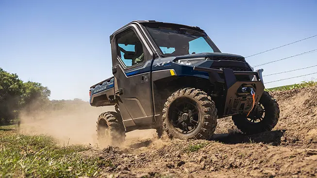 side profile of a ranger xp 1000 utv on a farm trail