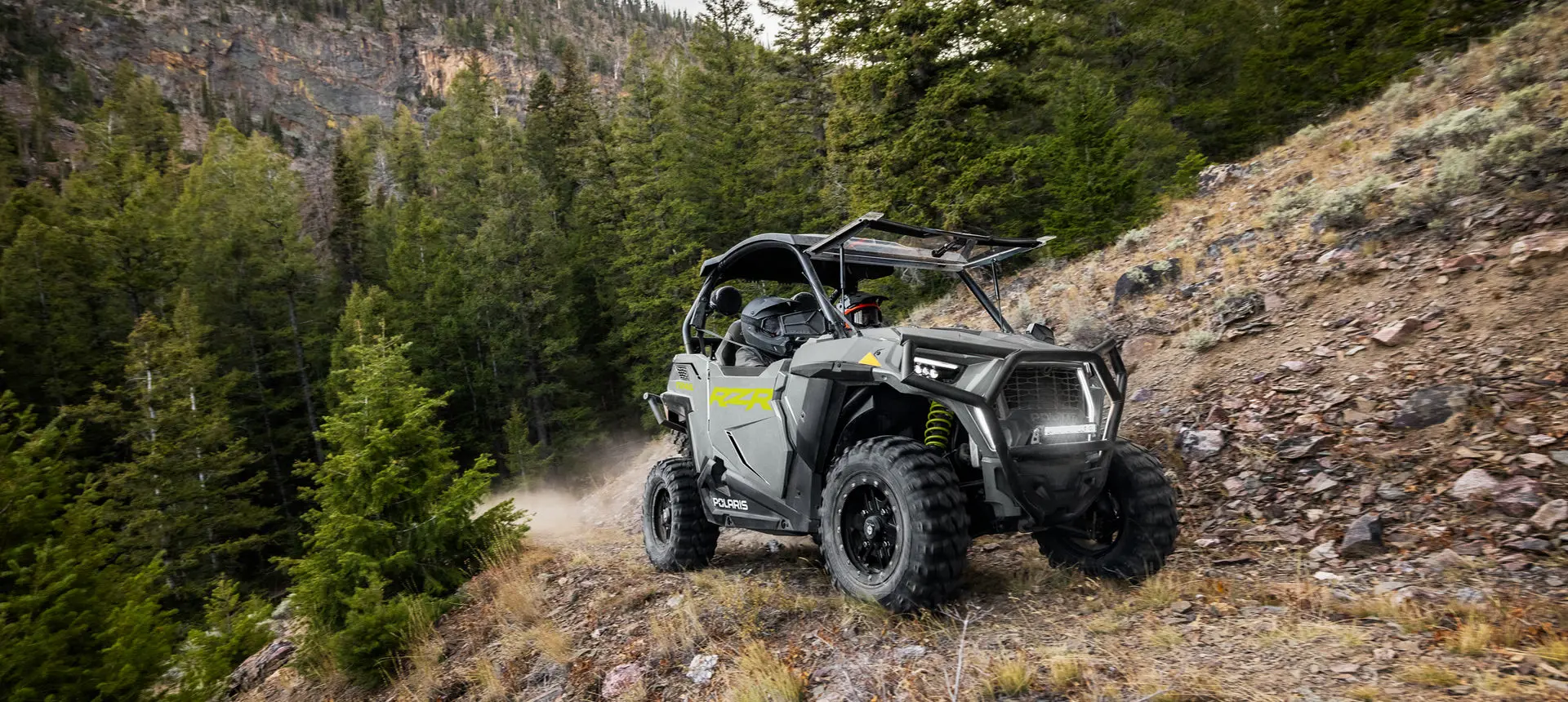 side profile of a rzr trail side by side on a hillside trail