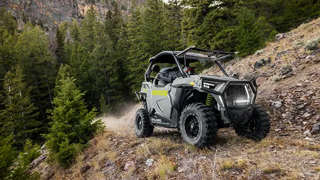 side profile of a rzr trail side by side on a hillside trail