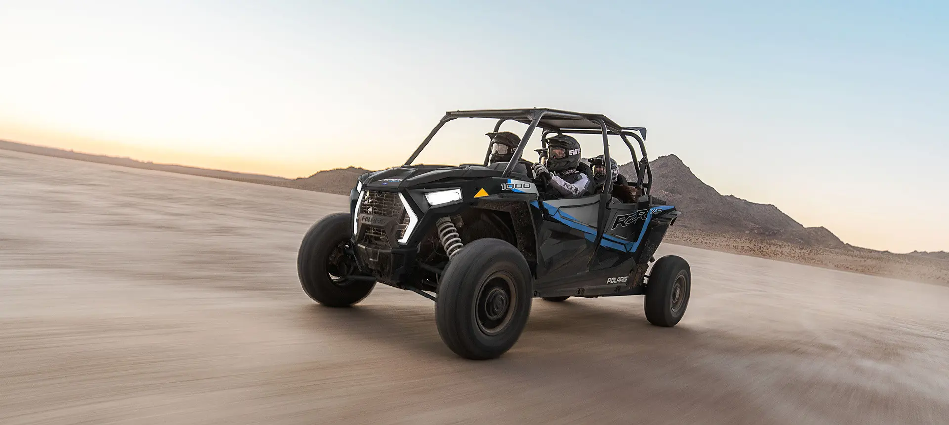 4 riders in a rzr xp 4 1000 side by side in the desert