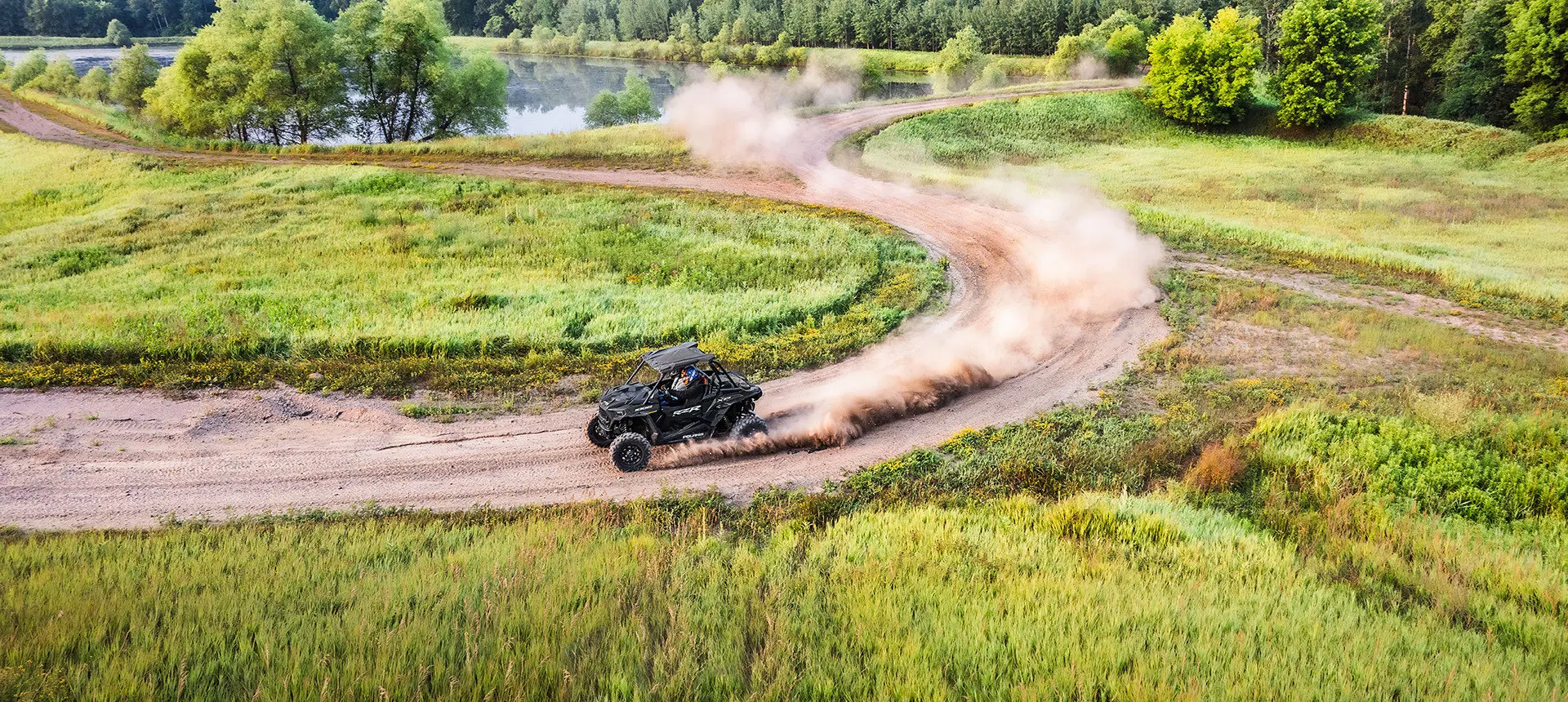 rzr xp 1000 side by side taking a corner on a dusty trail