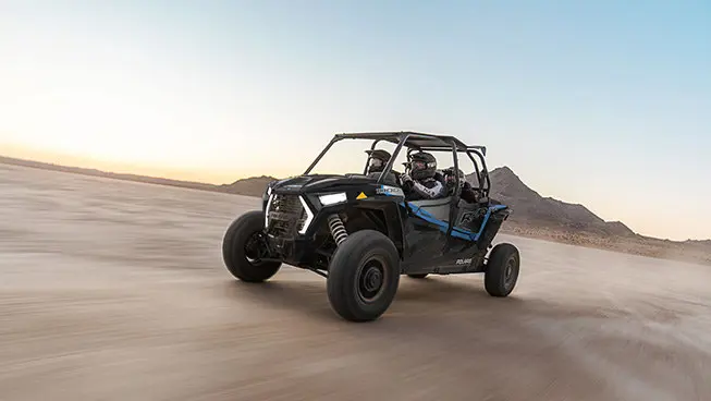 4 riders in a rzr xp 4 1000 side by side in the desert