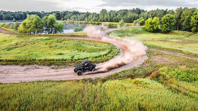 rzr xp 1000 side by side taking a corner on a dusty trail