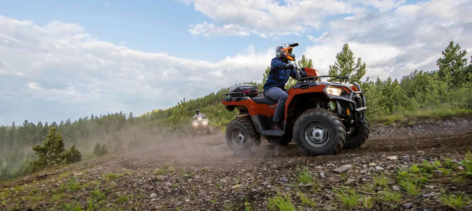 sportsman 570 atv cruising around a corner with another atv following
