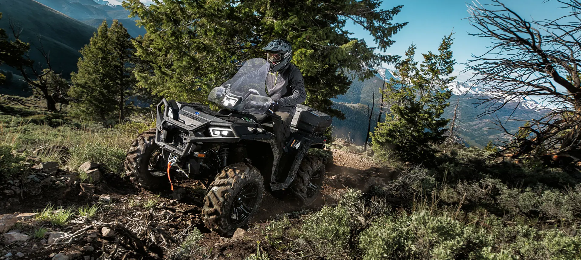 sportsman xp 1000 atv cruising on a mountain trail