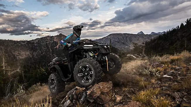 sportsman xp 1000 atv powering over rocky terrain with ease