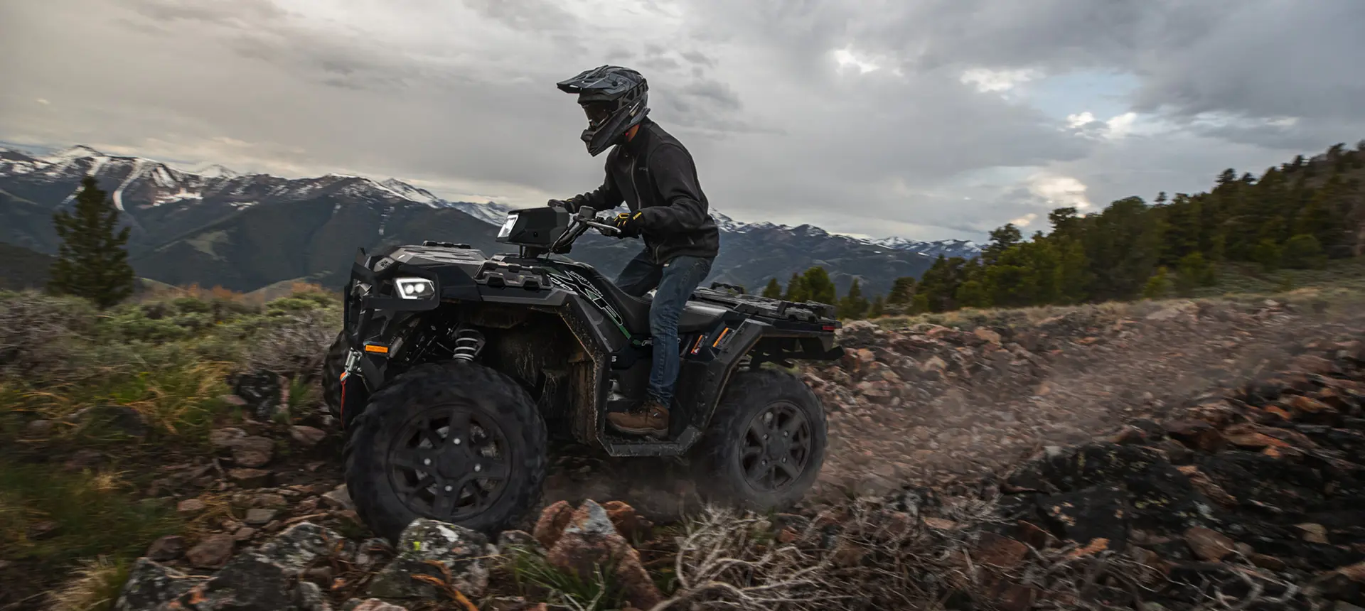 side profile of a sportsman xp 1000 atv on a rocky mountain trail