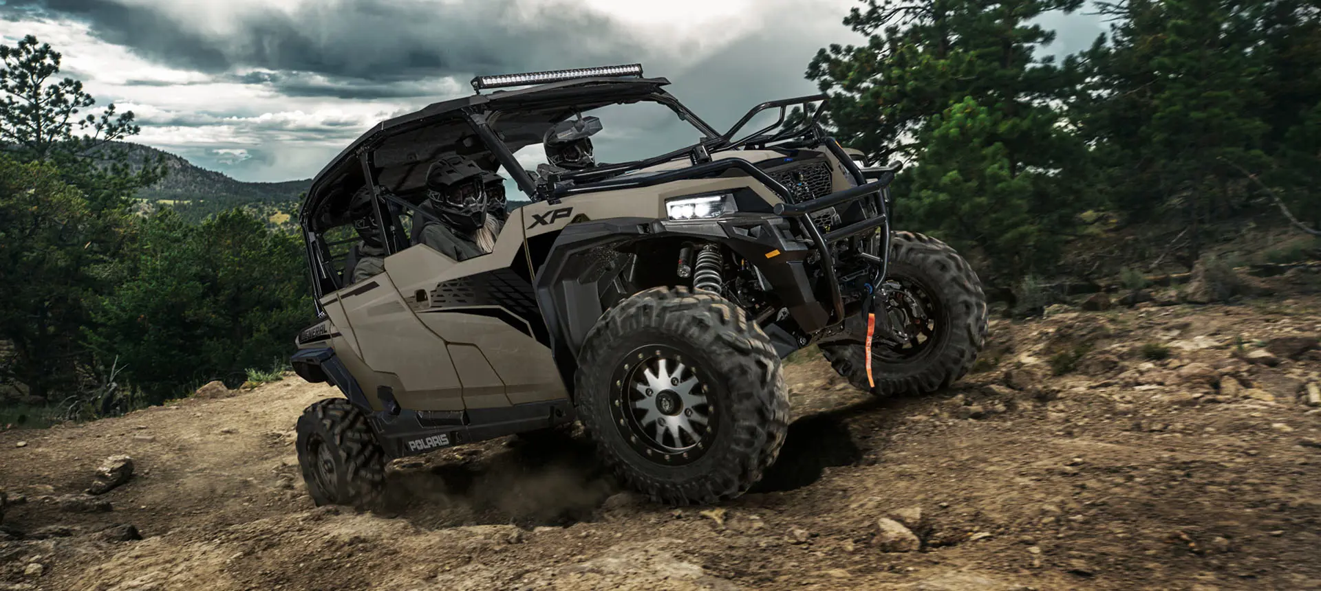 GENERAL XP 4 1000 side by side climbing over rocky terrain