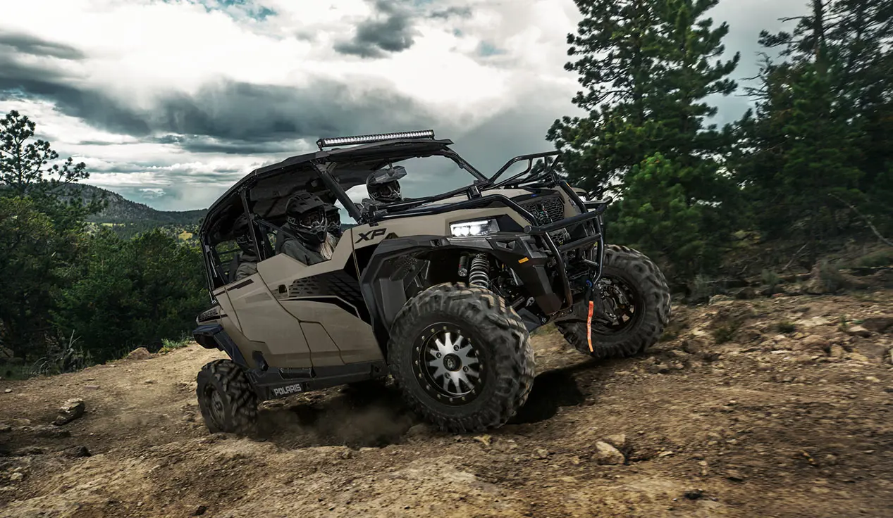 GENERAL XP 4 1000 side by side climbing over rocky terrain