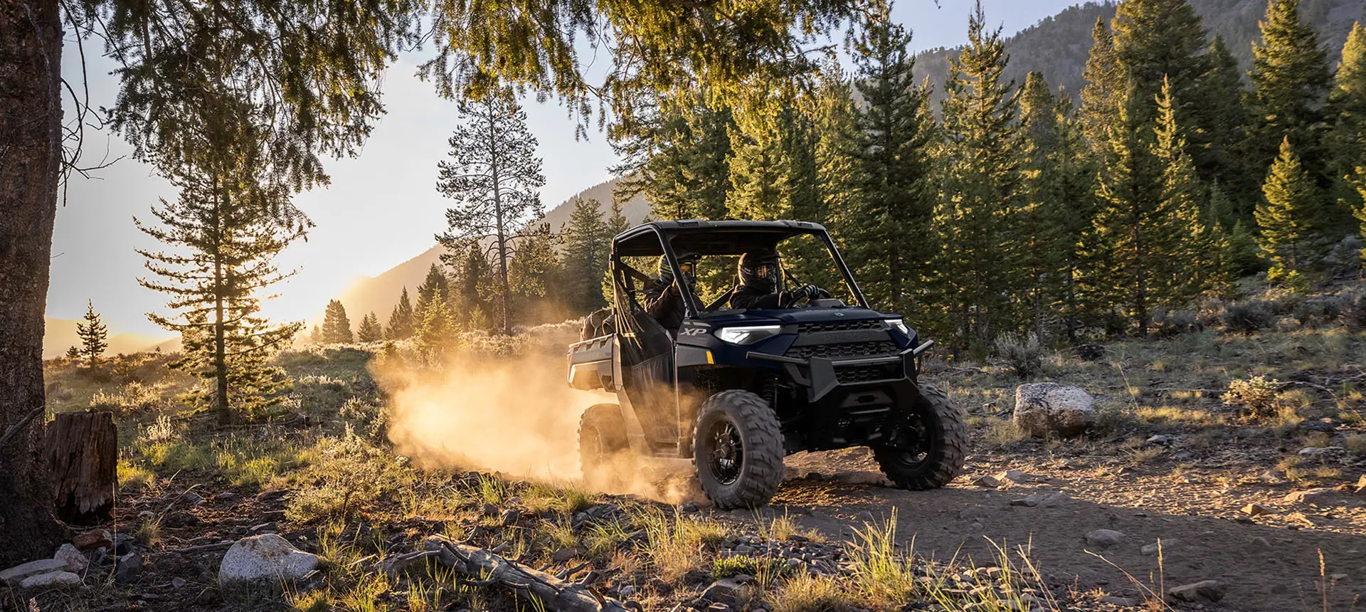 2 riders in a RANGER XP 1000 utv on a trail