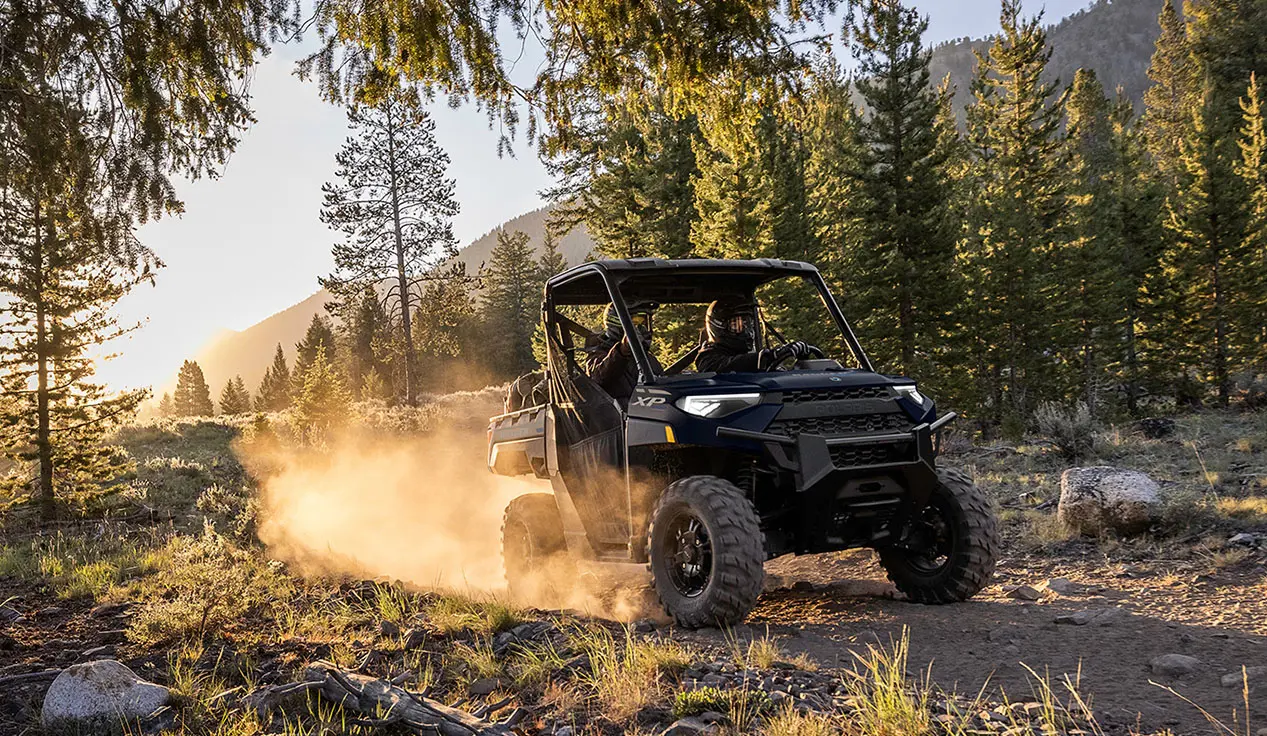 2 riders in a RANGER XP 1000 utv on a trail
