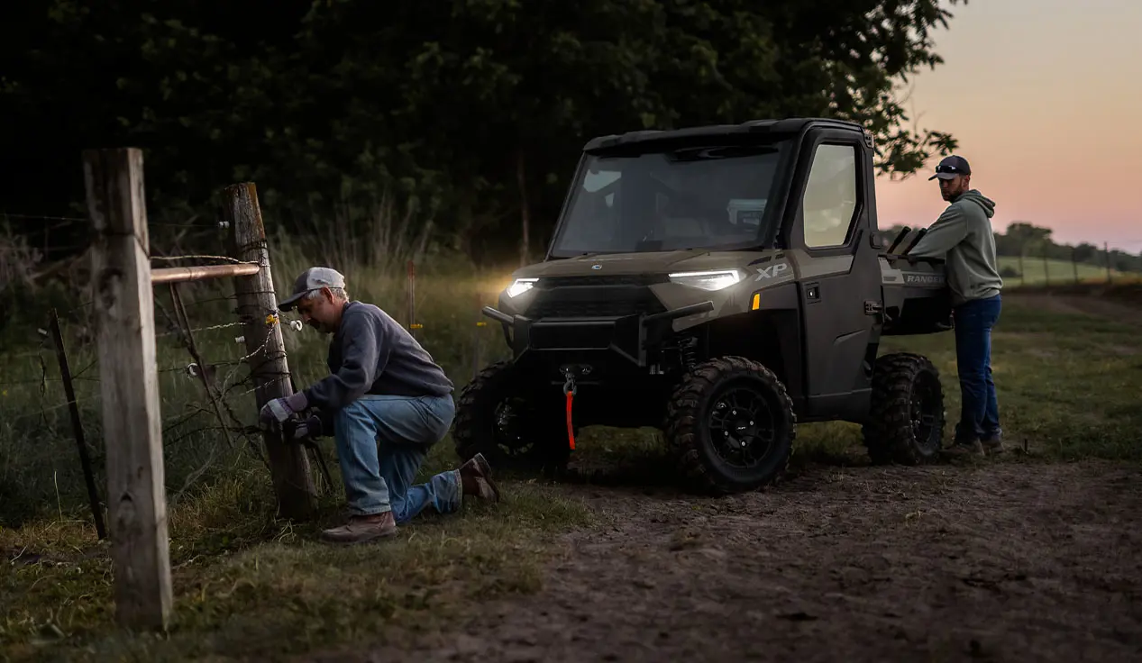 farmers fixing fence in the light of their RANGER XP 1000 NorthStar Edition UTV