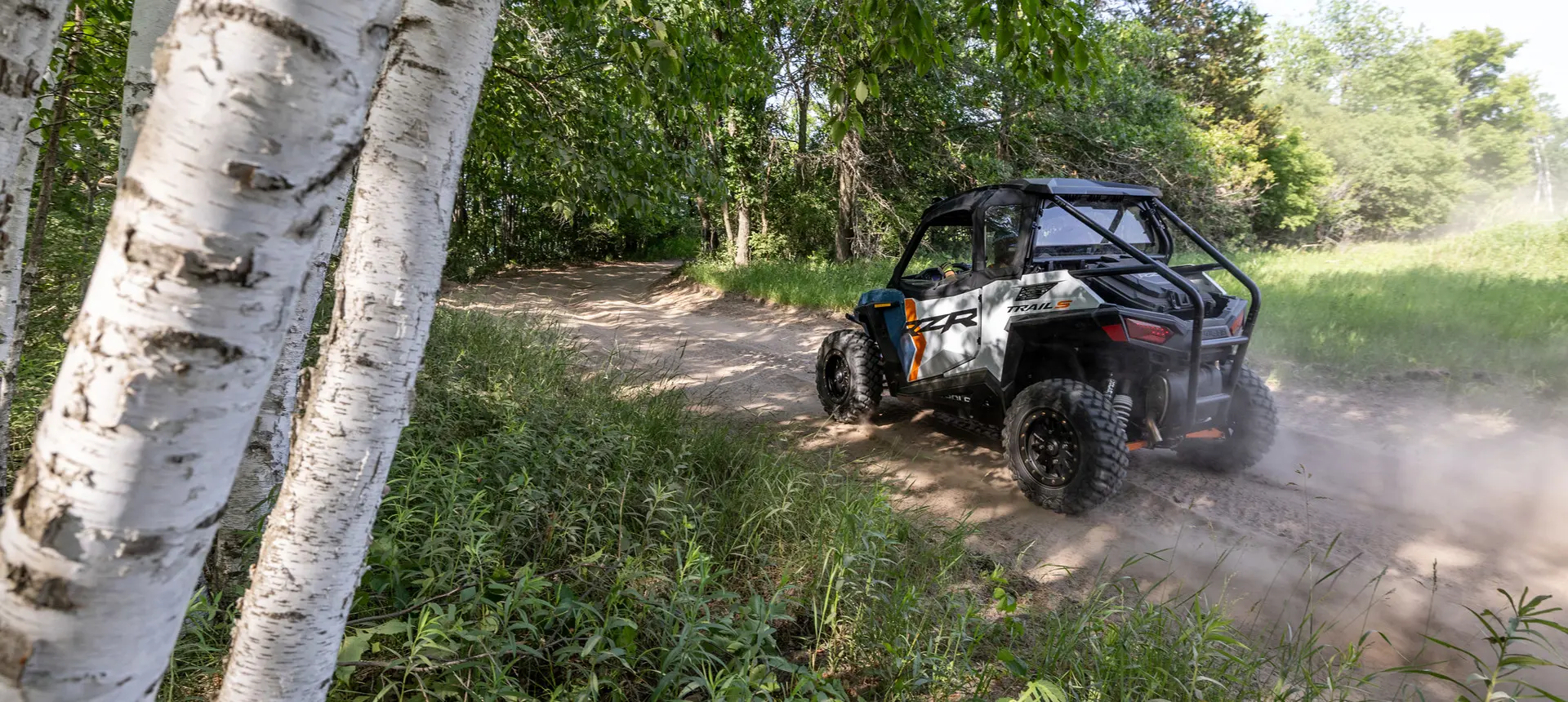 rear view of a rzr trail s side by side on a dirt road