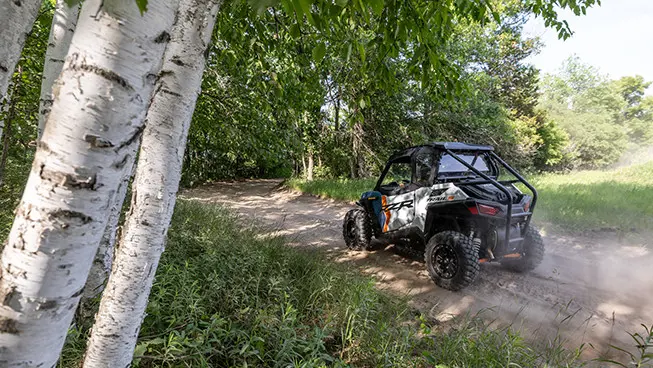 rear view of a rzr trail s side by side on a dirt road