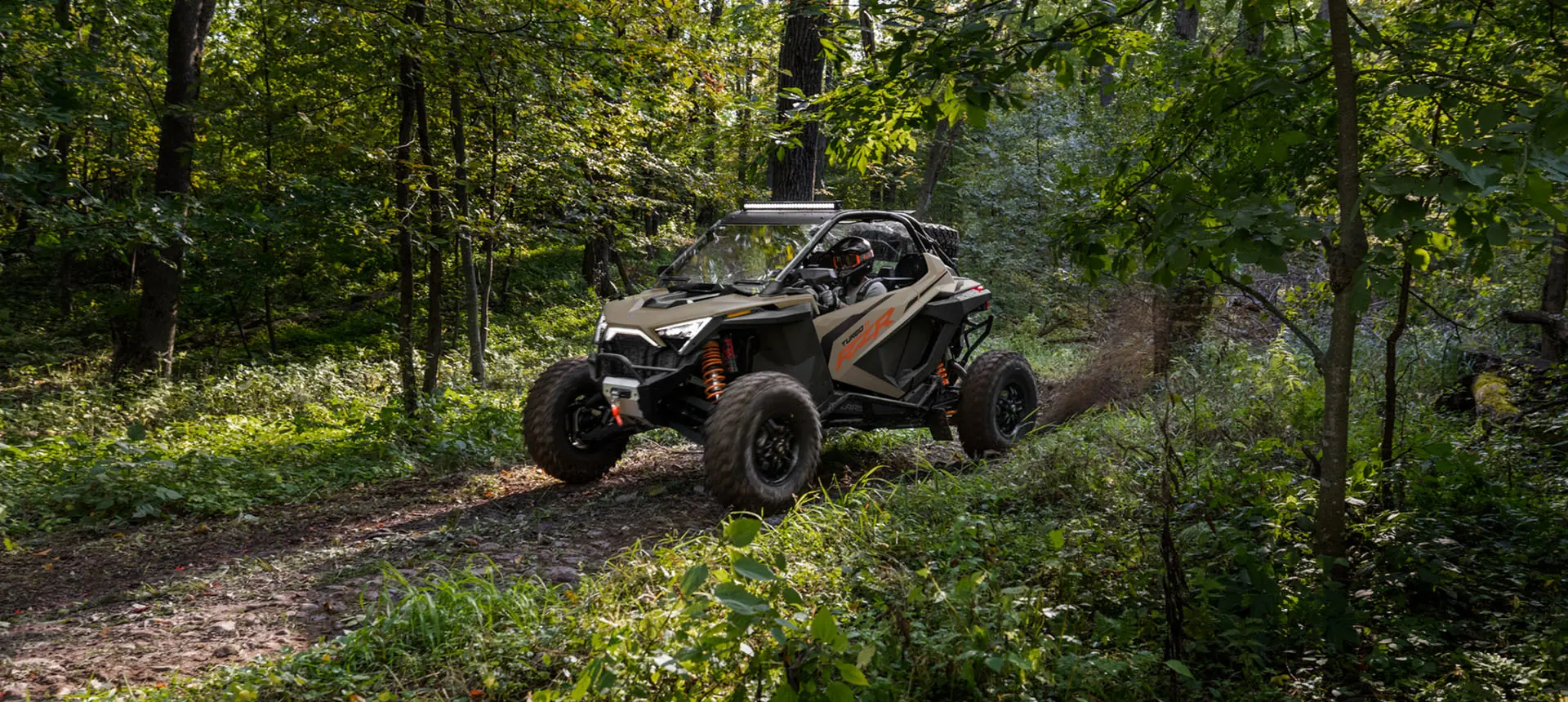 rzr turbo r side by side on a forest trail