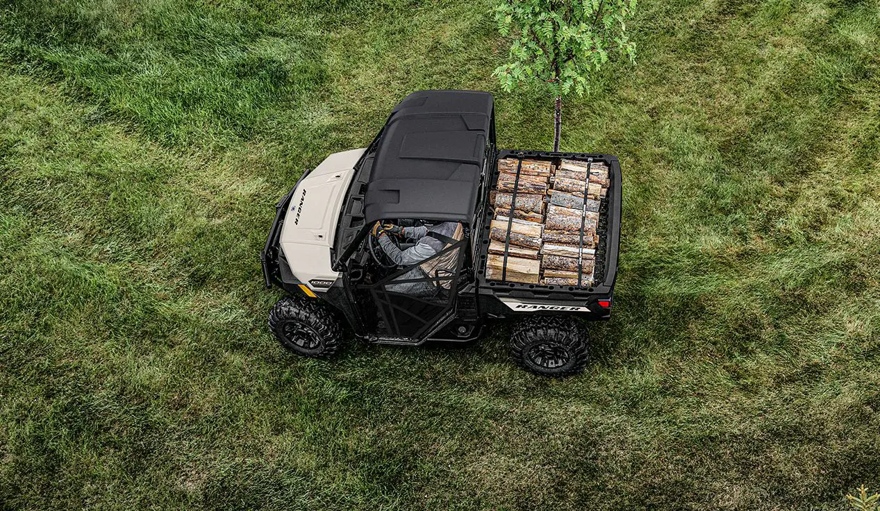Aerial view of a Polaris RANGER 1000 UTV with a load of lumber in the cargo box.