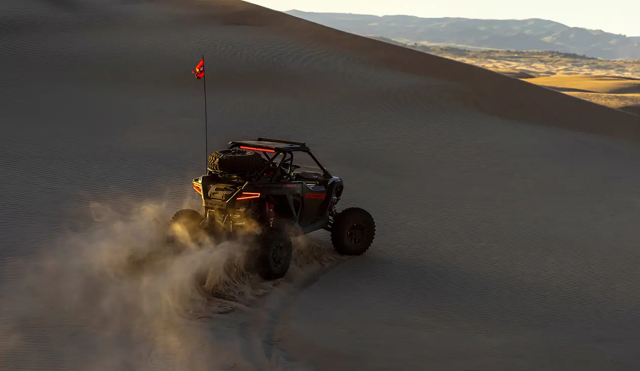 Polaris RZR Pro S side-by-side climbing a hill in the desert.