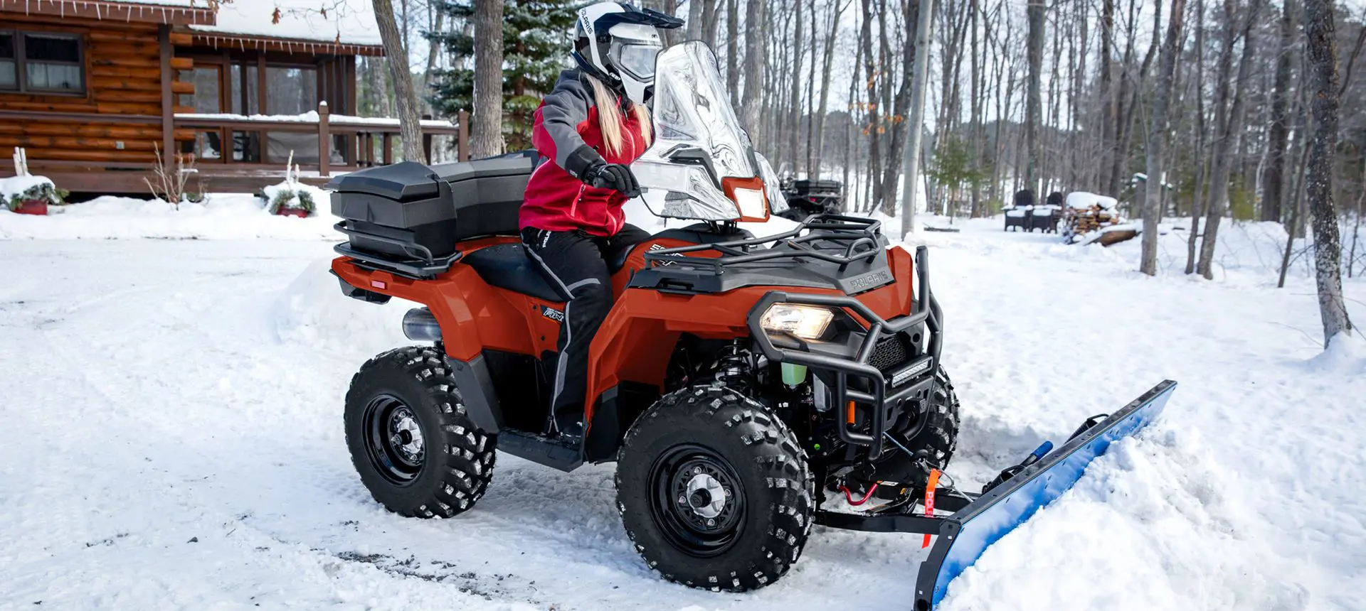 Polaris Sportsman 450 ATV with a plow attached in the winter.