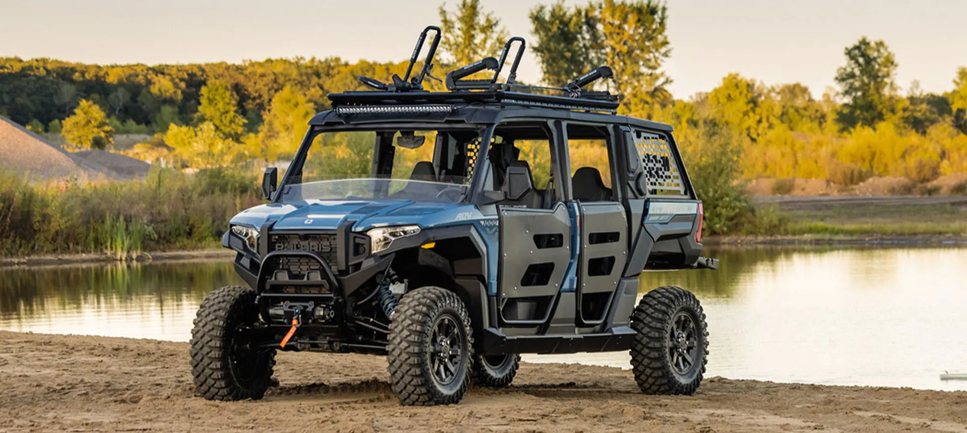 Polaris XPEDITION ADV 5 side-by-side parked near a lake.