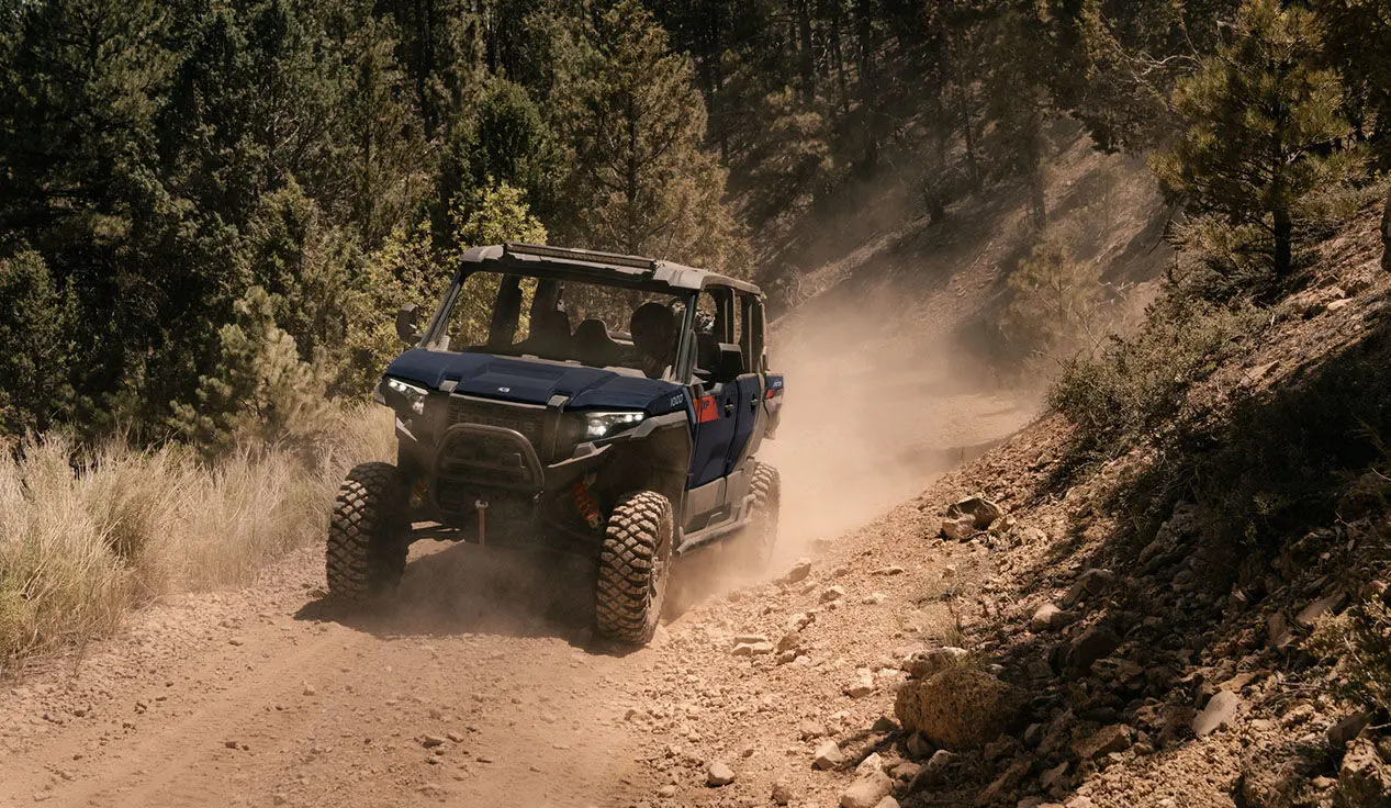 Polaris XPEDITION XP 5 side-by-side driving on a dusty trail.