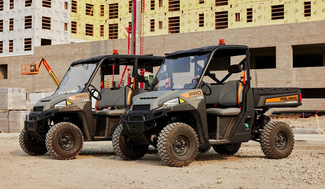 Two Polaris Pro XD Full-Size Diesel UTVs at a jobsite.