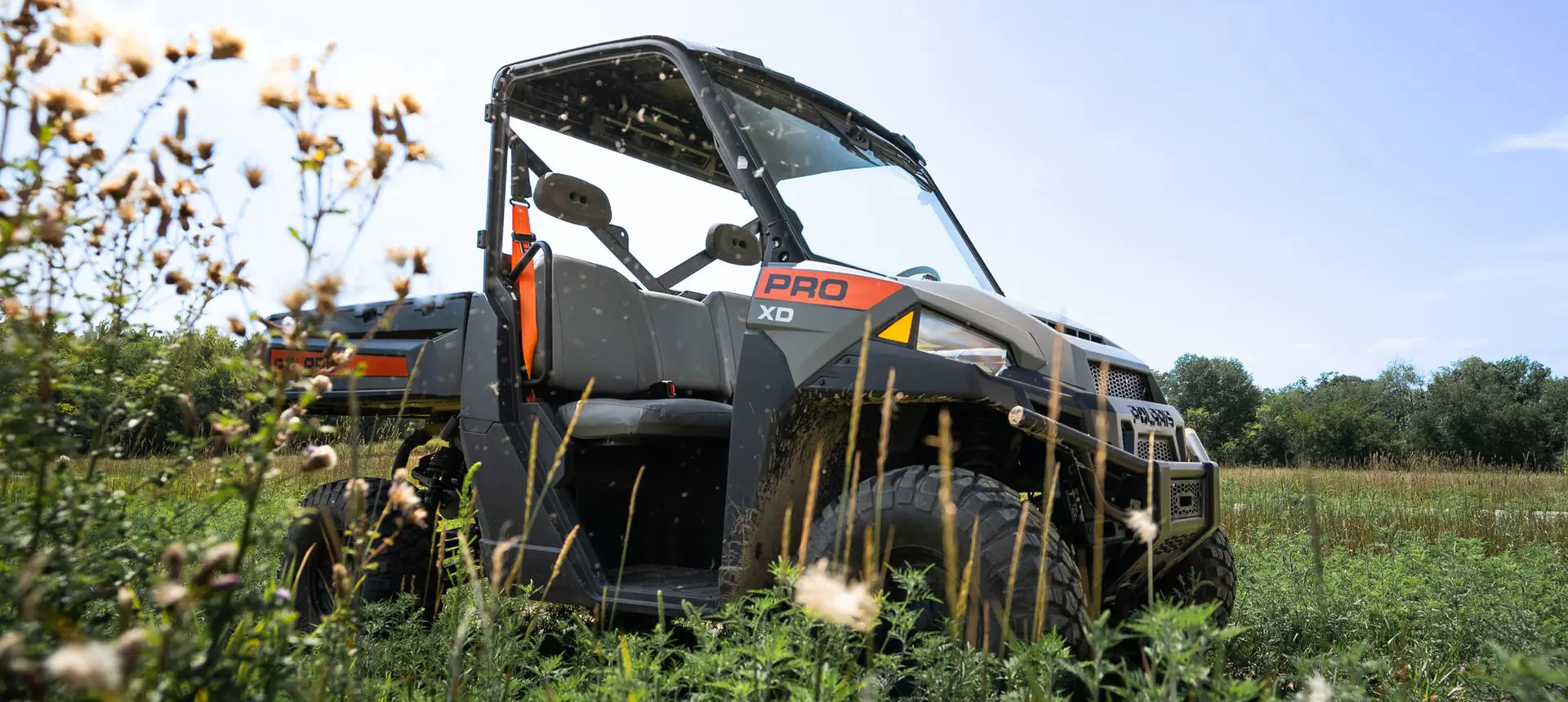 Side profile of a Polaris Pro XD Full-Size diesel work UTV in a field.
