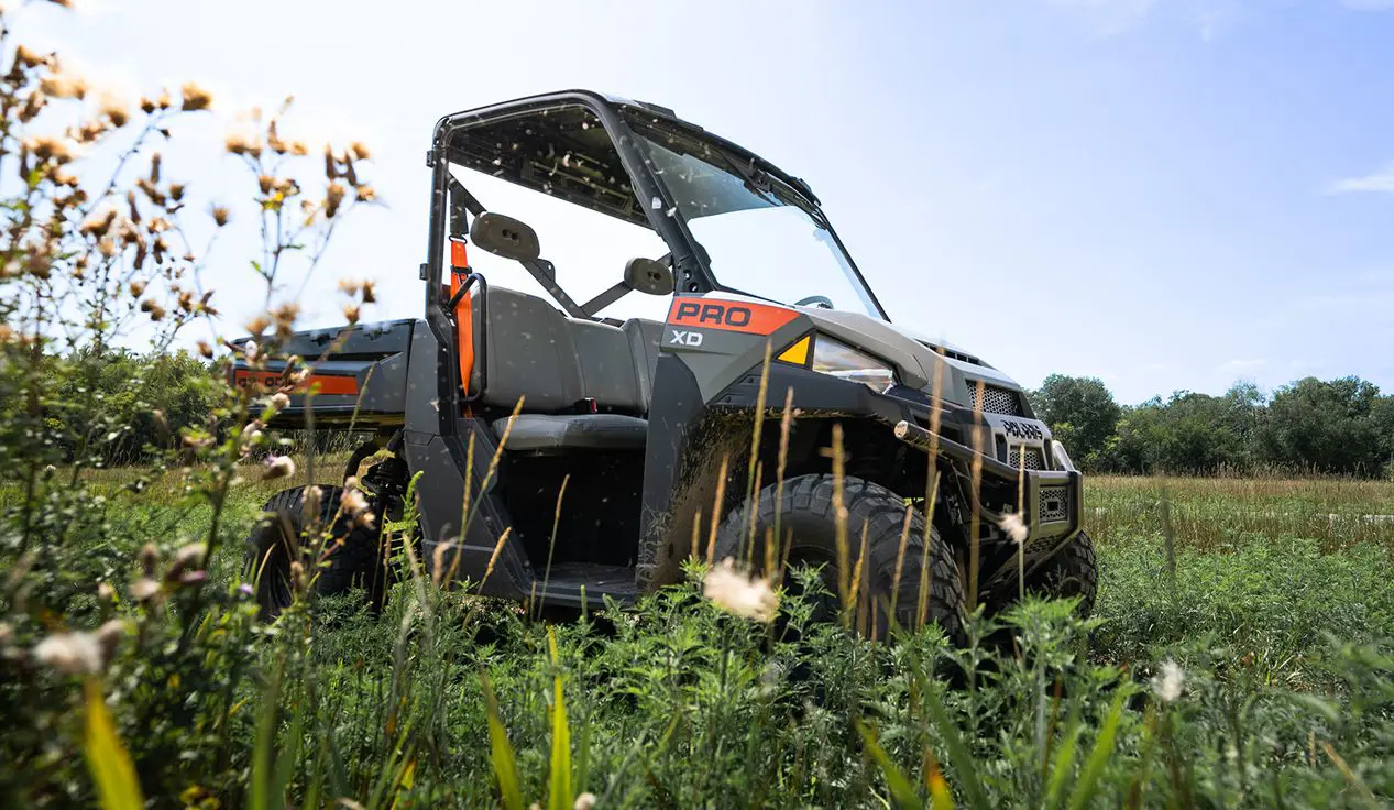 Side profile of a Polaris Pro XD Full-Size diesel work UTV in a field.