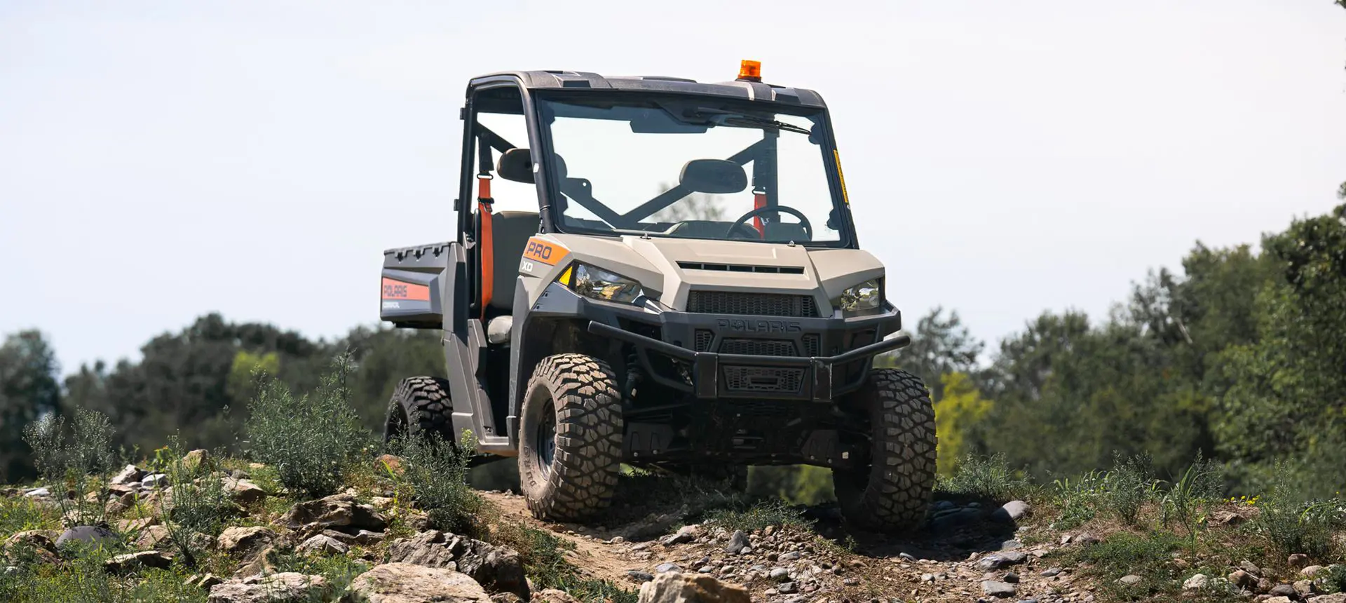 Front view of a Polaris Pro XD Full-Size diesel work UTV on a hill.