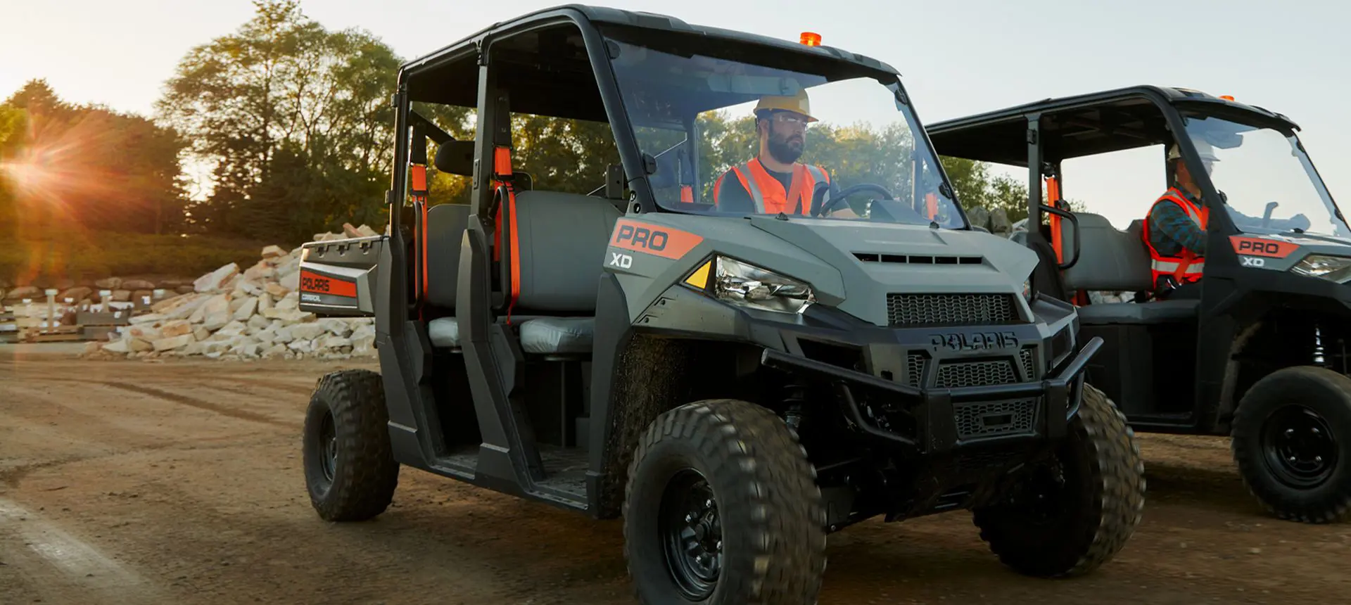 Construction worker driving a Polaris Pro XD Full-Size diesel work UTV on the jobsite.