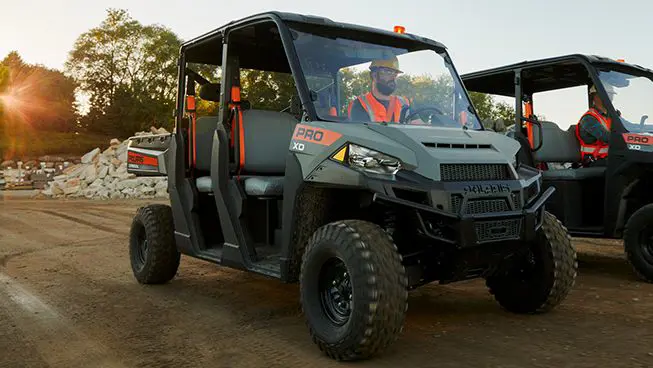 Construction worker driving a Polaris Pro XD Full-Size diesel work UTV on the jobsite.