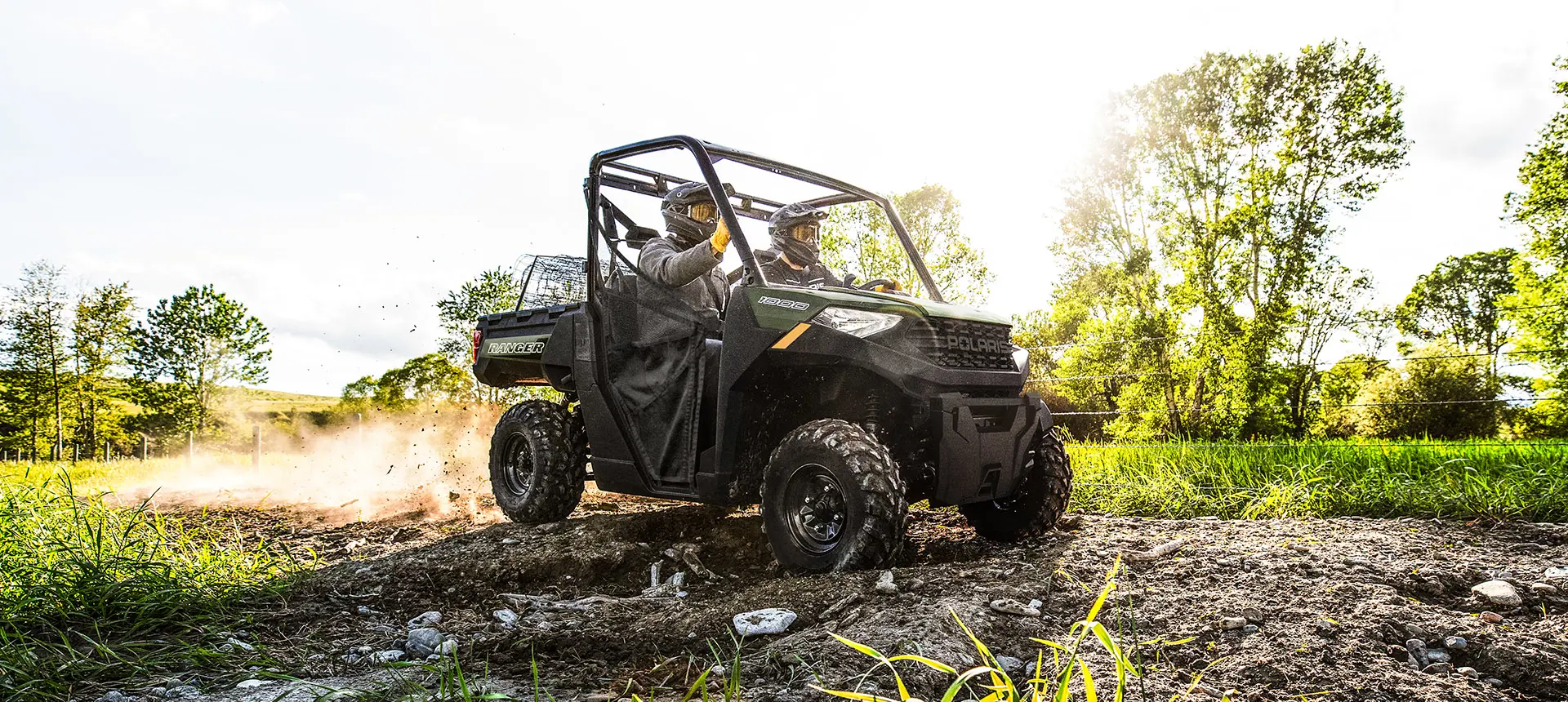 Two people trail riding in a Polaris RANGER 1000 UTV.