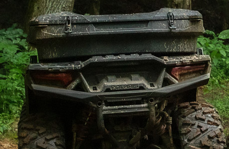 A Polaris Sportsman XP 1000 Ultimate ATV with cargo storage accessories installed.