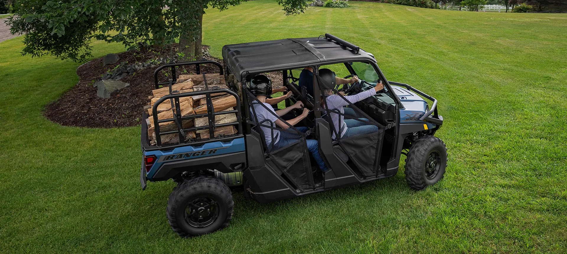 Overhead view of people hauling wood with a Polaris RANGER UTV.
