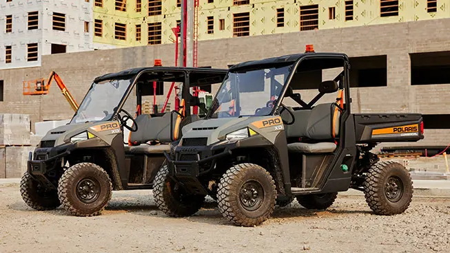 Polaris Pro XD UTVs being used for grounds and facility operations on a jobsite.