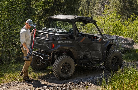 A Polaris GENERAL SxS with storage rack accessories installed.