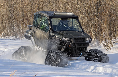 A Polaris GENERAL SxS with tracks and other winter accessories installed.