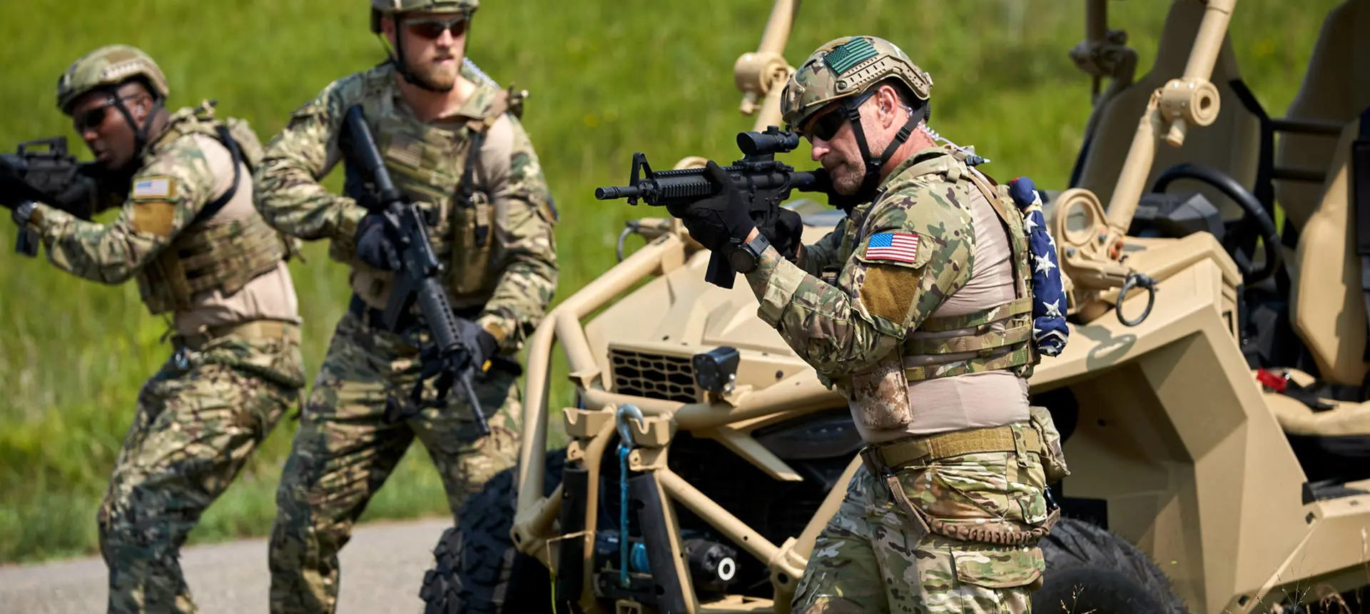 3 soldiers ready for action near an MRZR Alpha XP military tactical side-by-side.