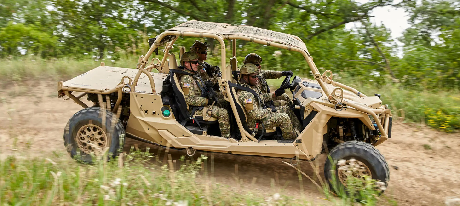 Side profile of 4 soldiers riding in a MRZR Alpha military tactical side-by-side.
