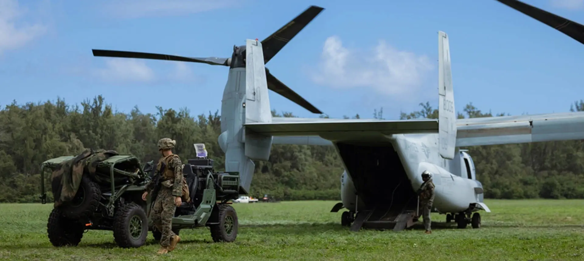 A soldier preparing to load an MRZR Alpha military tactical side-by-side into an aircraft for transportation.