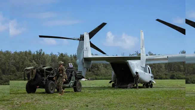 A soldier preparing to load an MRZR Alpha military tactical side-by-side into an aircraft for transportation.