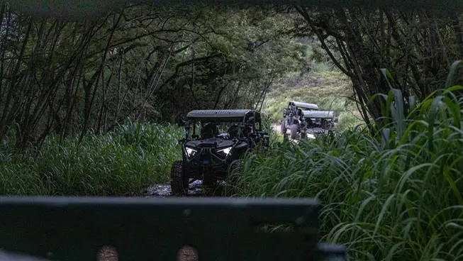 3 MRZR Alpha military tactical side-by-sides driving in the jungle.