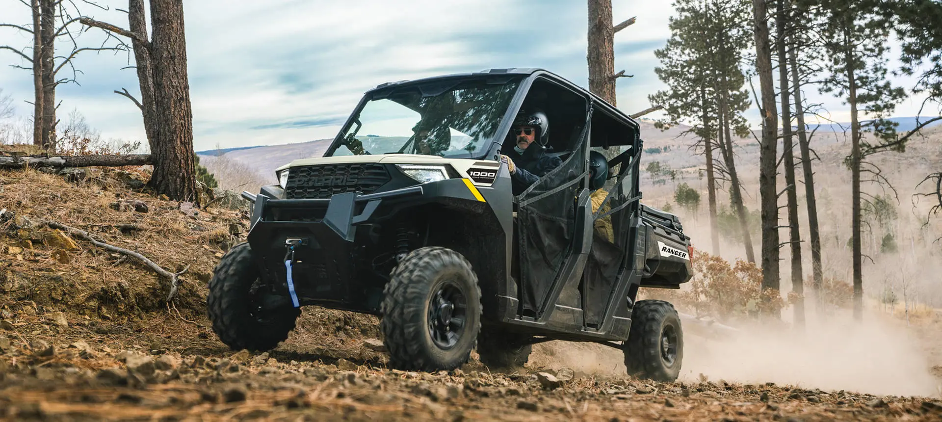 Polaris RANGER CREW 1000 UTV cruising a trail with 4 riders inside.