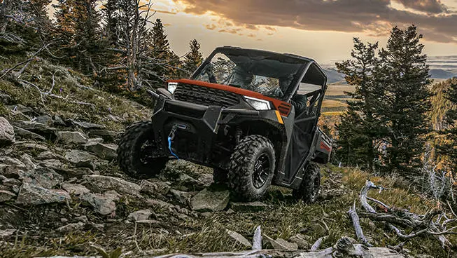 A Polaris RANGER 1000 UTV climbing over rocky terrain.