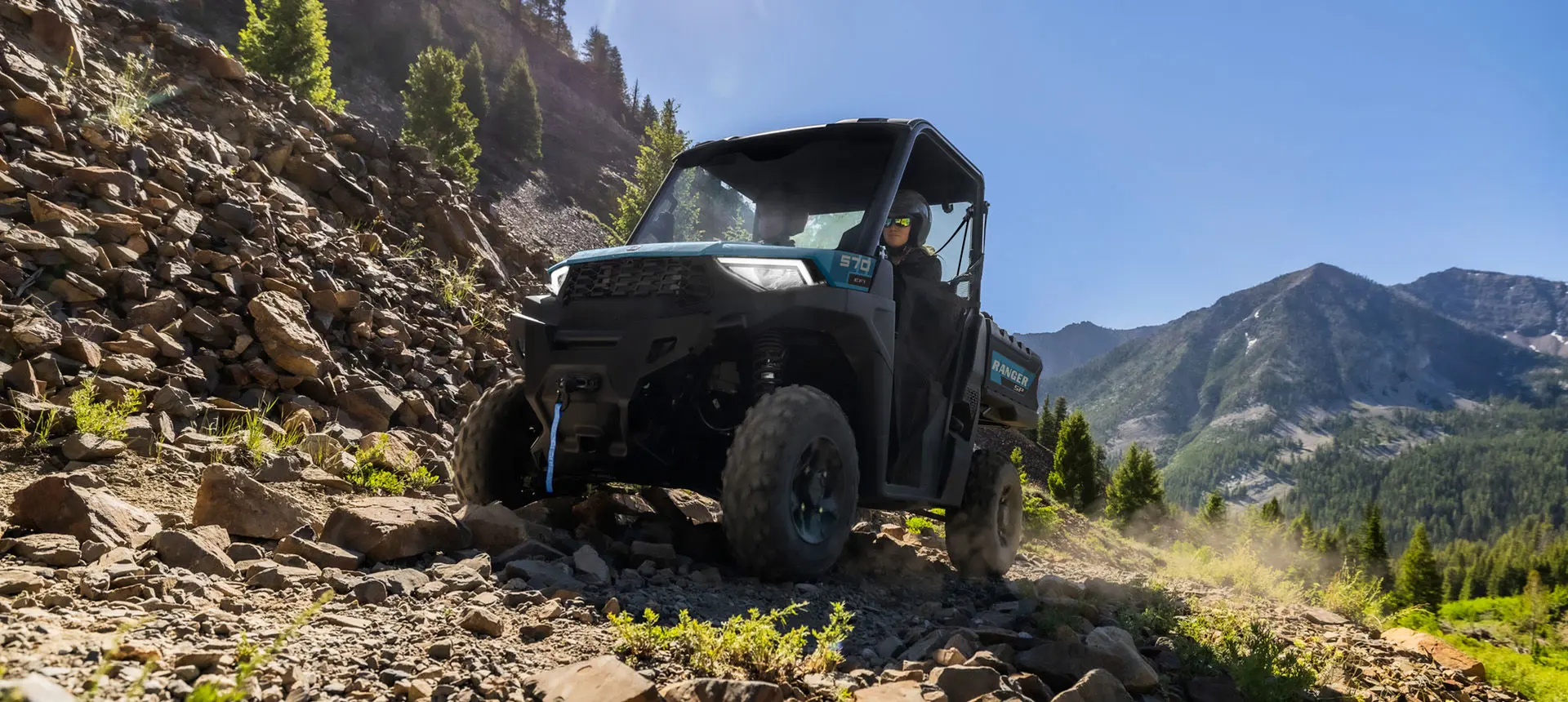 A Polaris RANGER SP 570 UTV driving over rocky terrain with ease.