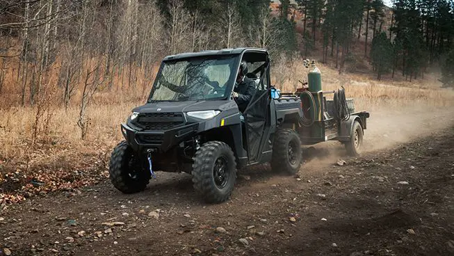 A Polaris RANGER XP 1000 UTV  pulling a heavy trailer with ease.